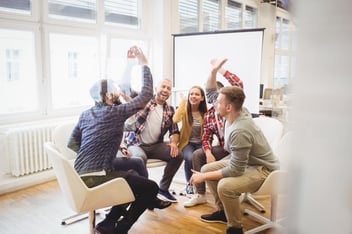 Group of people celebrating in office